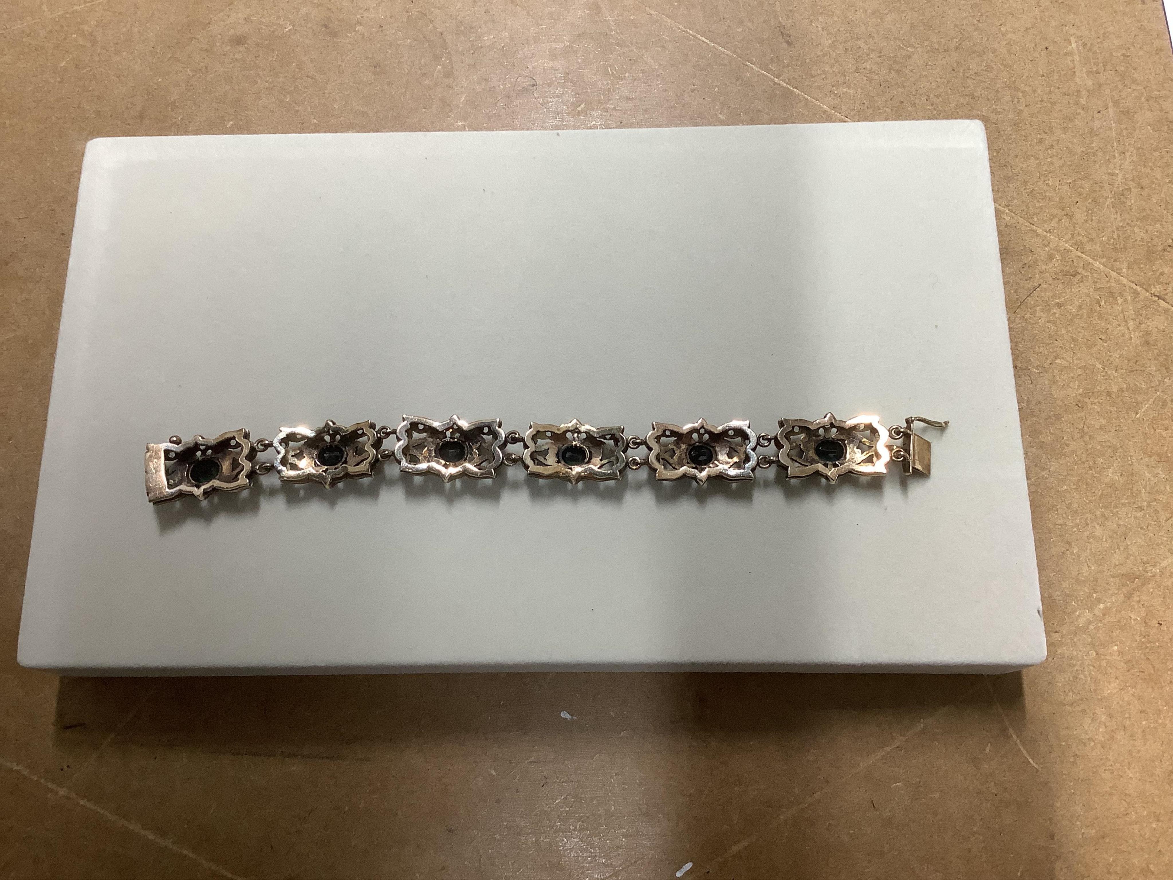 A jewellery case and a collection of jewellery, comprising: an amethyst and peridot pendant in 9ct gold, length 3.8cm, British hallmarks, gross weight approximately 7 grams; a garnet cluster ring in 9ct gold, British hal